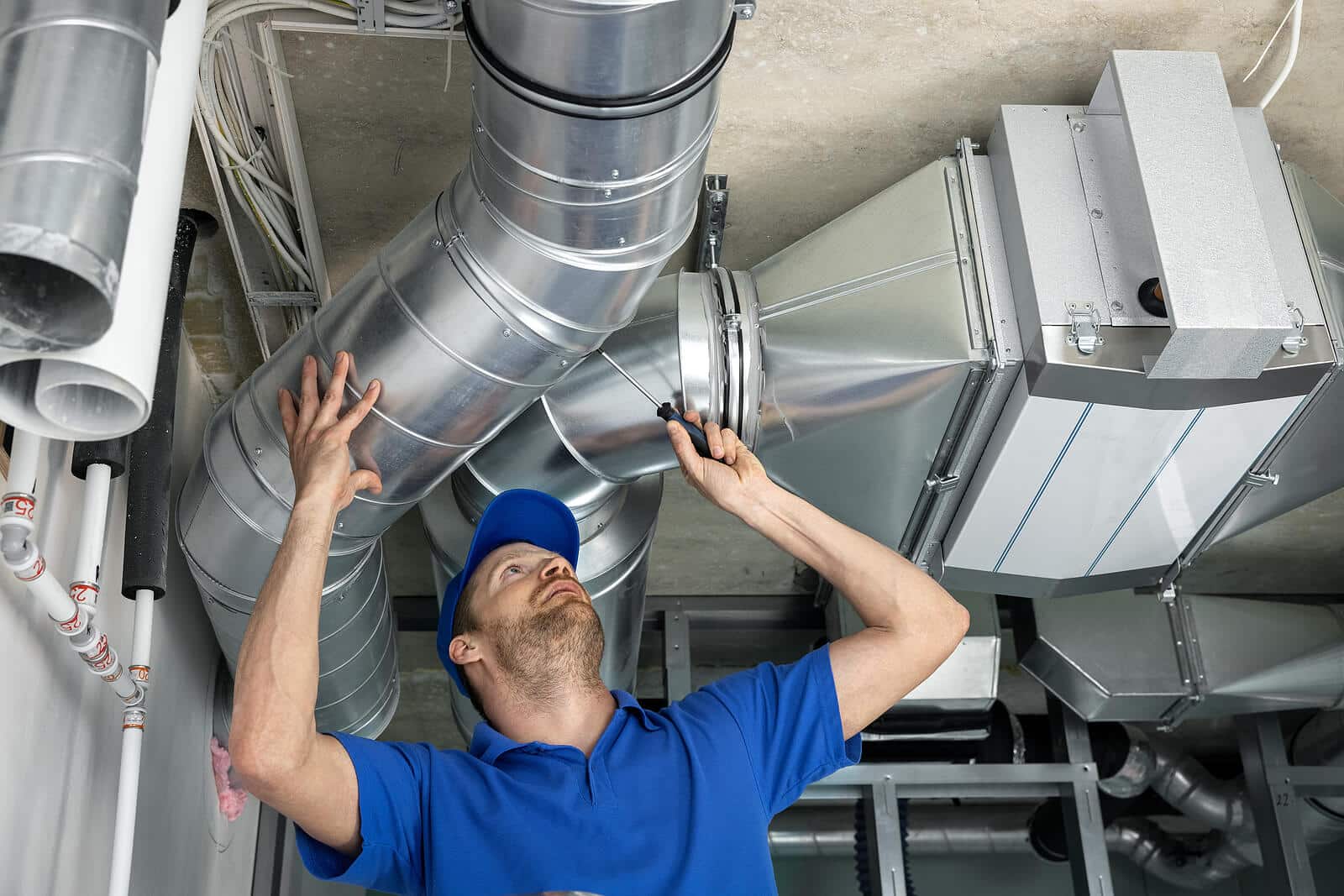 HVAC technician inspecting and repairing air ducts in Pacifica