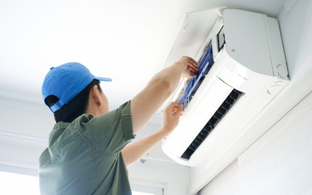 HVAC technician servicing a ductless mini split in Pacifica