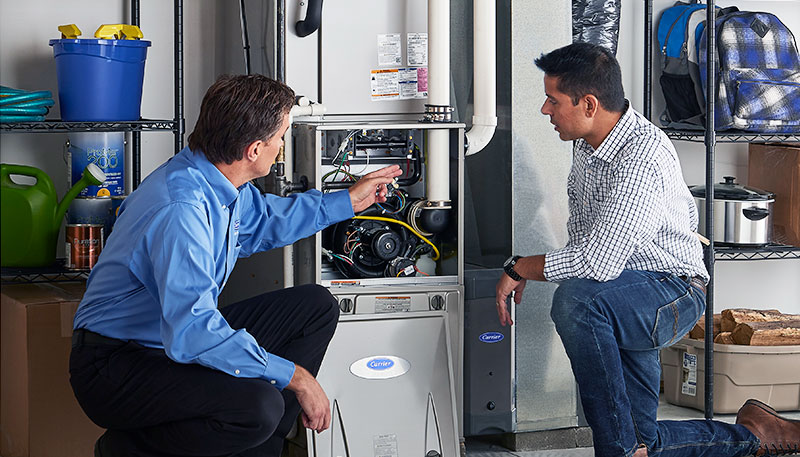 Technician evaluating a furnace for repair or replacement in Pacifica