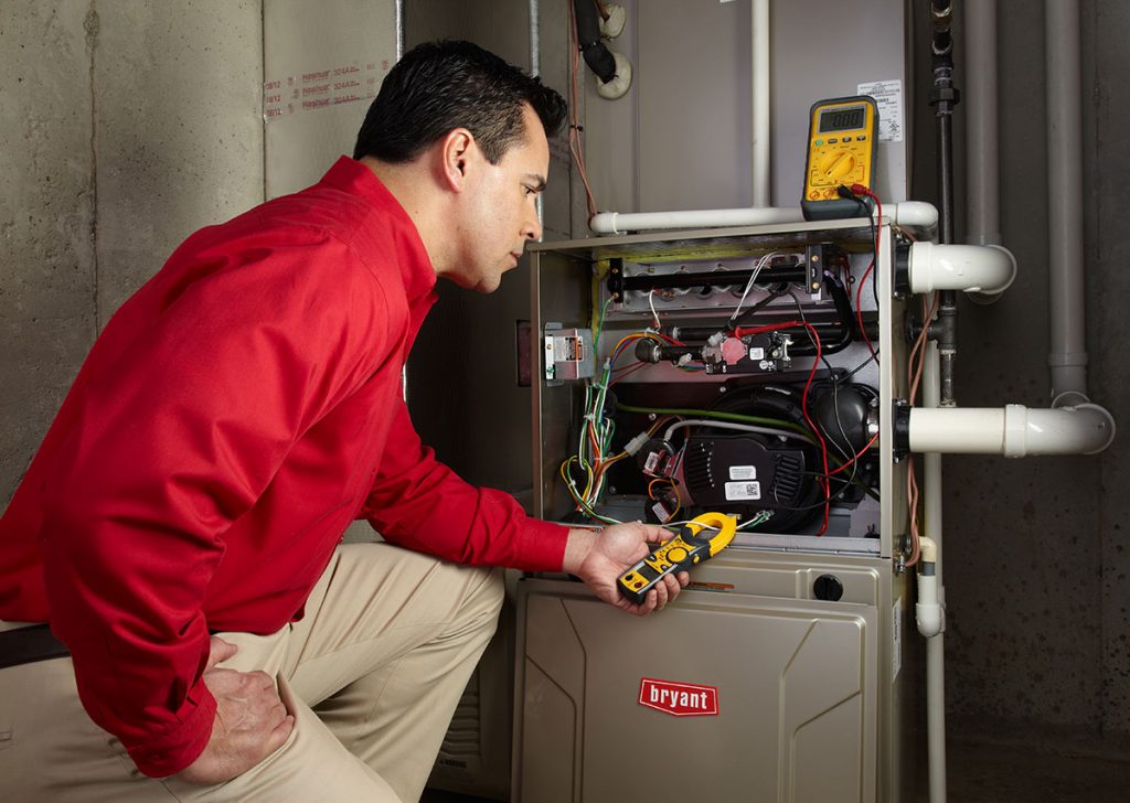 Heating technician diagnosing a furnace repair in Pacifica