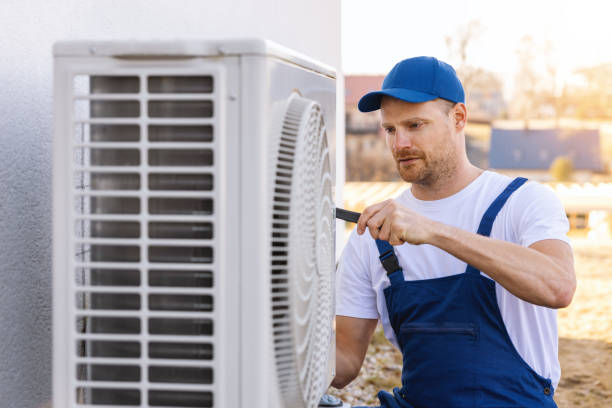 HVAC technician servicing an outdoor air conditioner in Pacifica