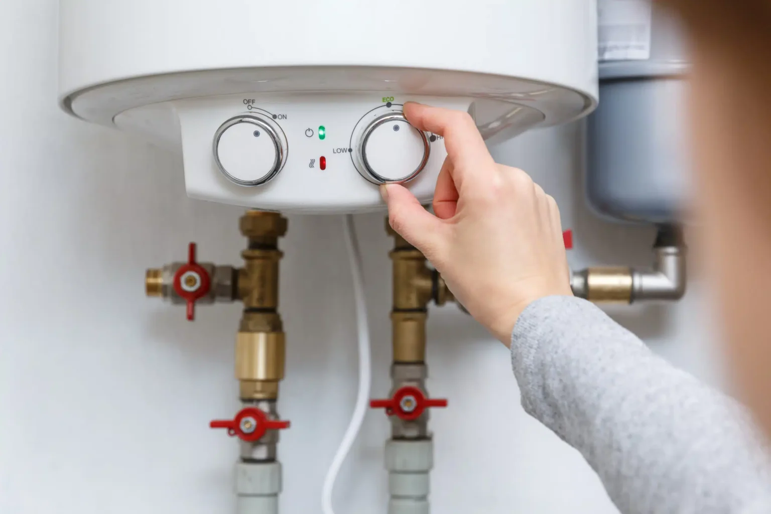 Technician adjusting a water heater in Pacifica